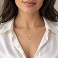 14K solid gold Pi Math necklace on woman wearing white satin shirt
