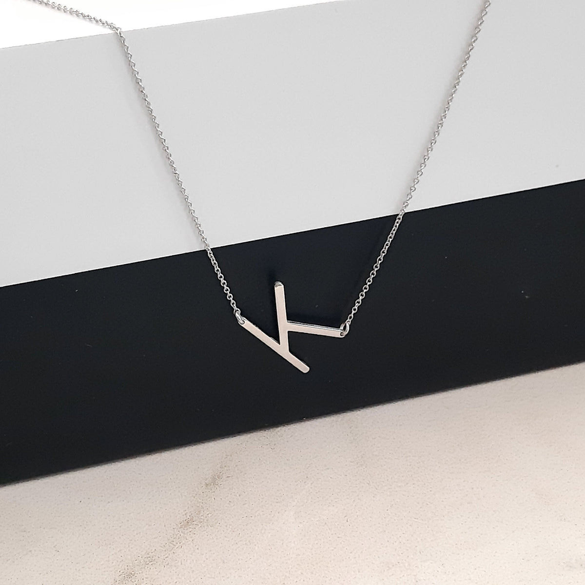 14K solid gold sideways letter necklace, styled product view