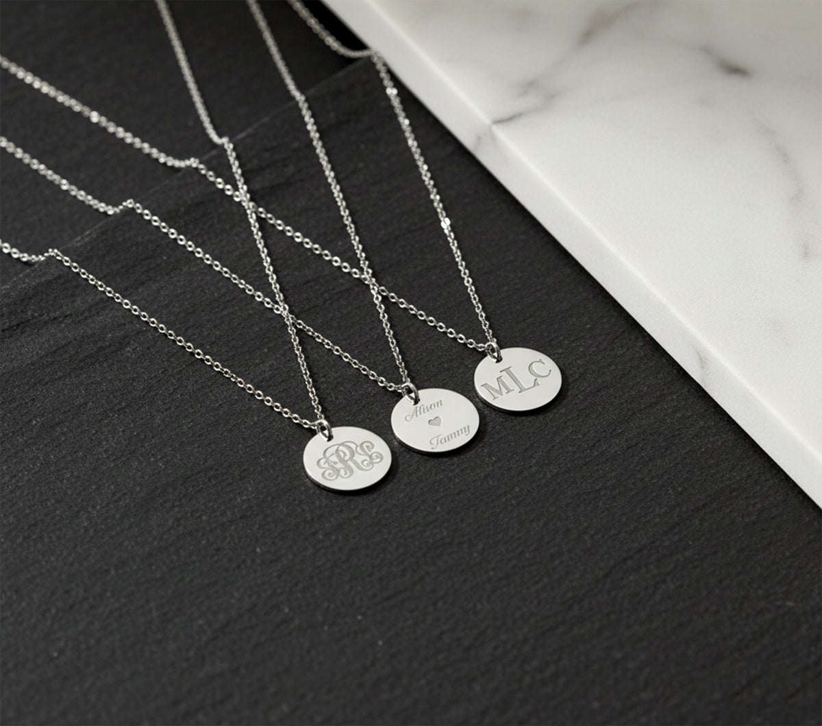 Close-up of 14K solid gold three-initial monogram necklace