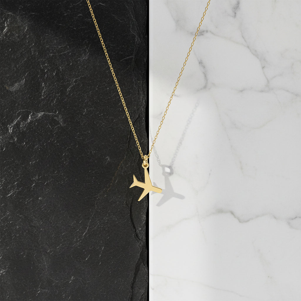 Close-up of 14K yellow gold airplane traveler necklace