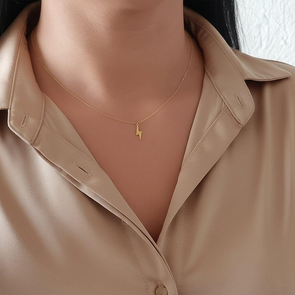 14K solid gold lightning bolt necklace, worn at the neckline