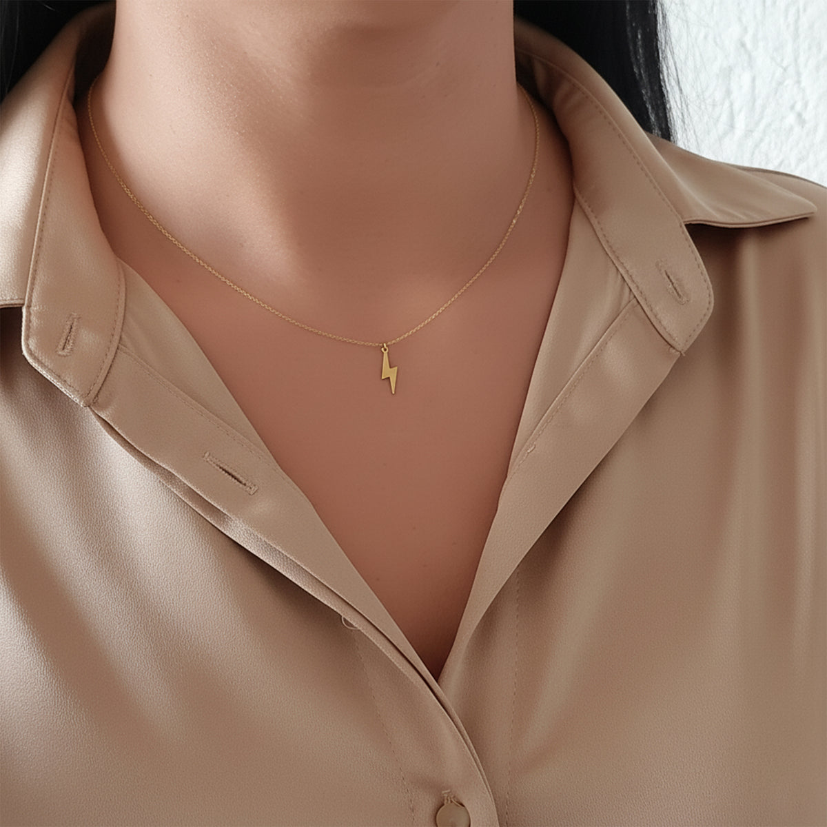 14K solid gold lightning bolt necklace, worn at the neckline