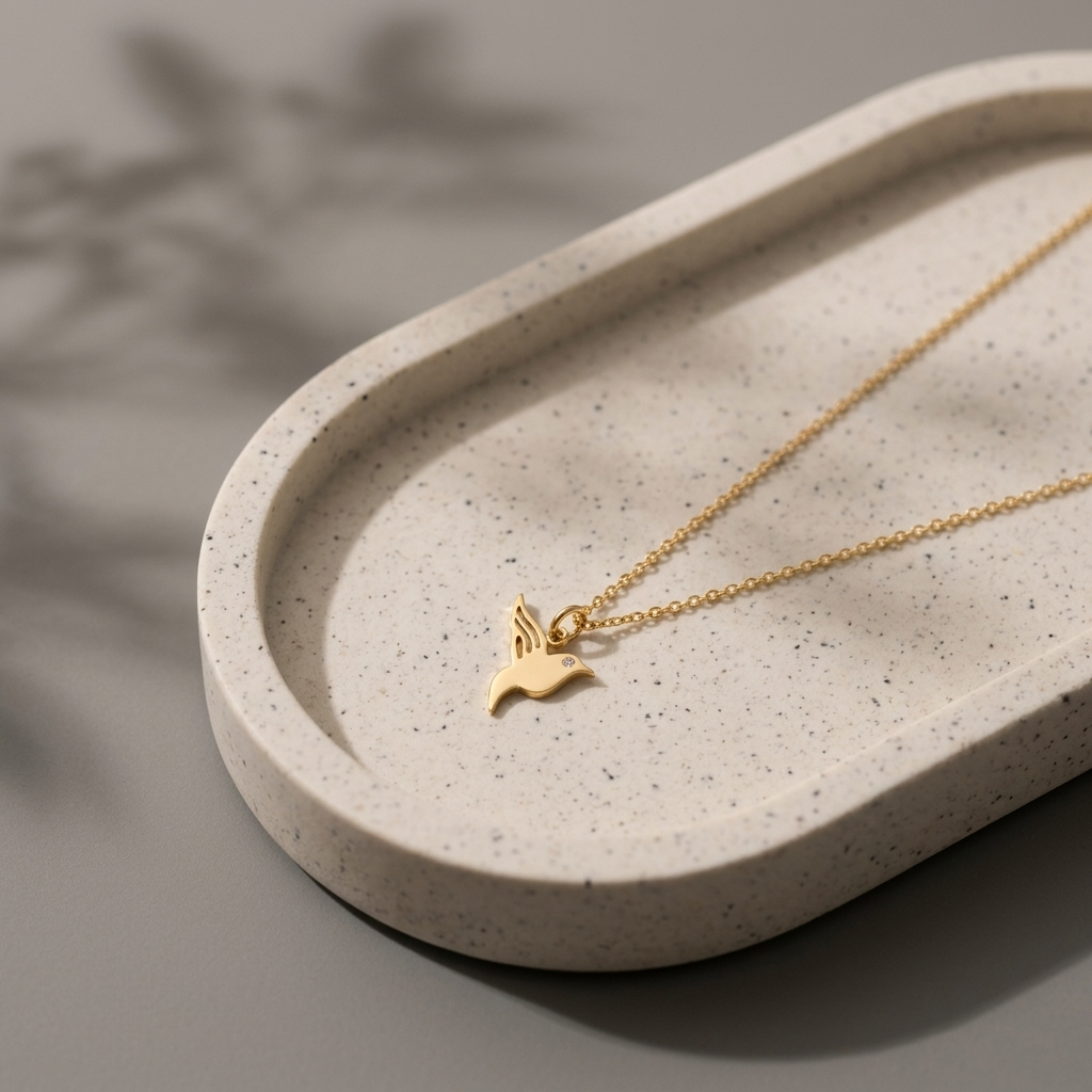 14K yellow gold hummingbird diamond pendant necklace, worn at the neckline