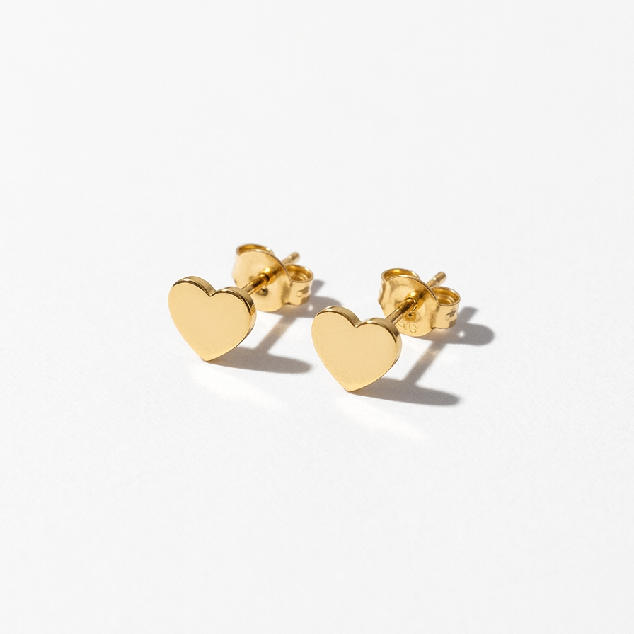 A pair of small gold heart stud earrings with flat polished hearts and butterfly backings, displayed on a clean white background.