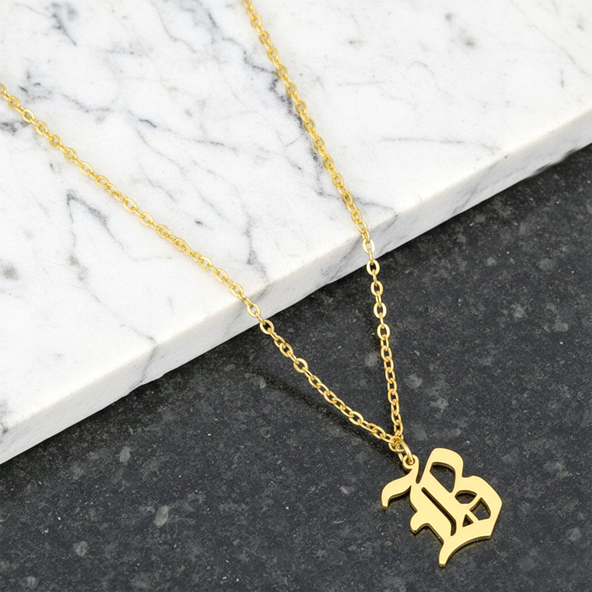 Close-up of 14K yellow gold old english initial necklace