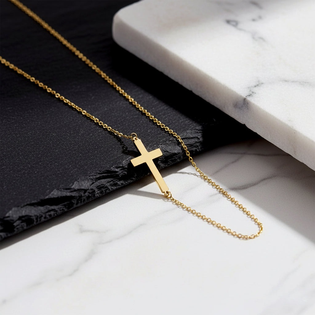 Close-up of 14K yellow gold cross necklace