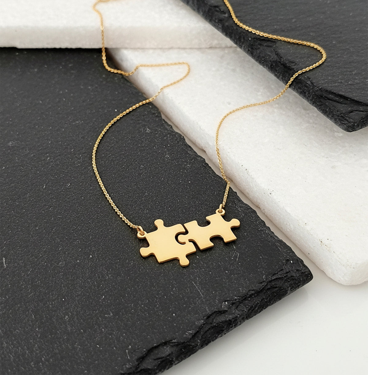 Close-up of 14K yellow gold friendship puzzle necklace