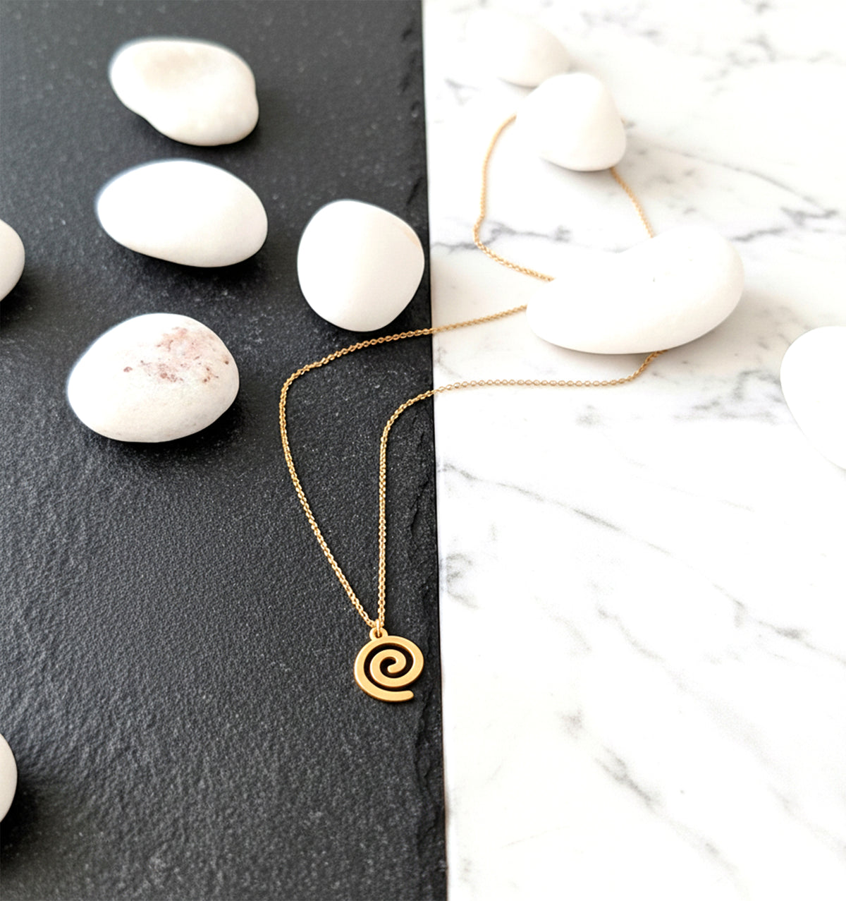 Close-up of 14K yellow gold spiral pendant necklace