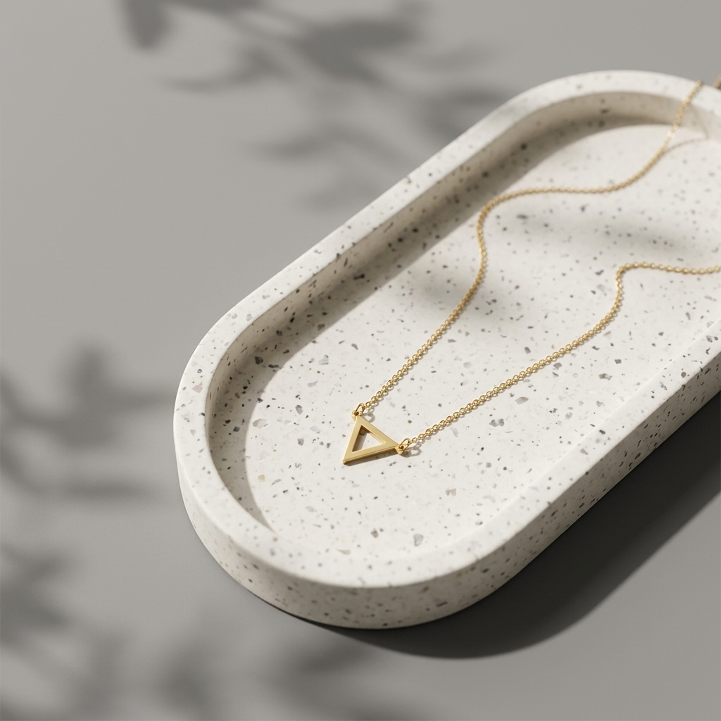 Close-up of 14K yellow gold dainty triangle necklace
