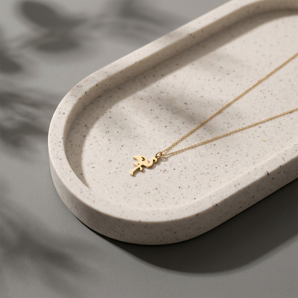 Close-up of 14K yellow gold flamingo necklace