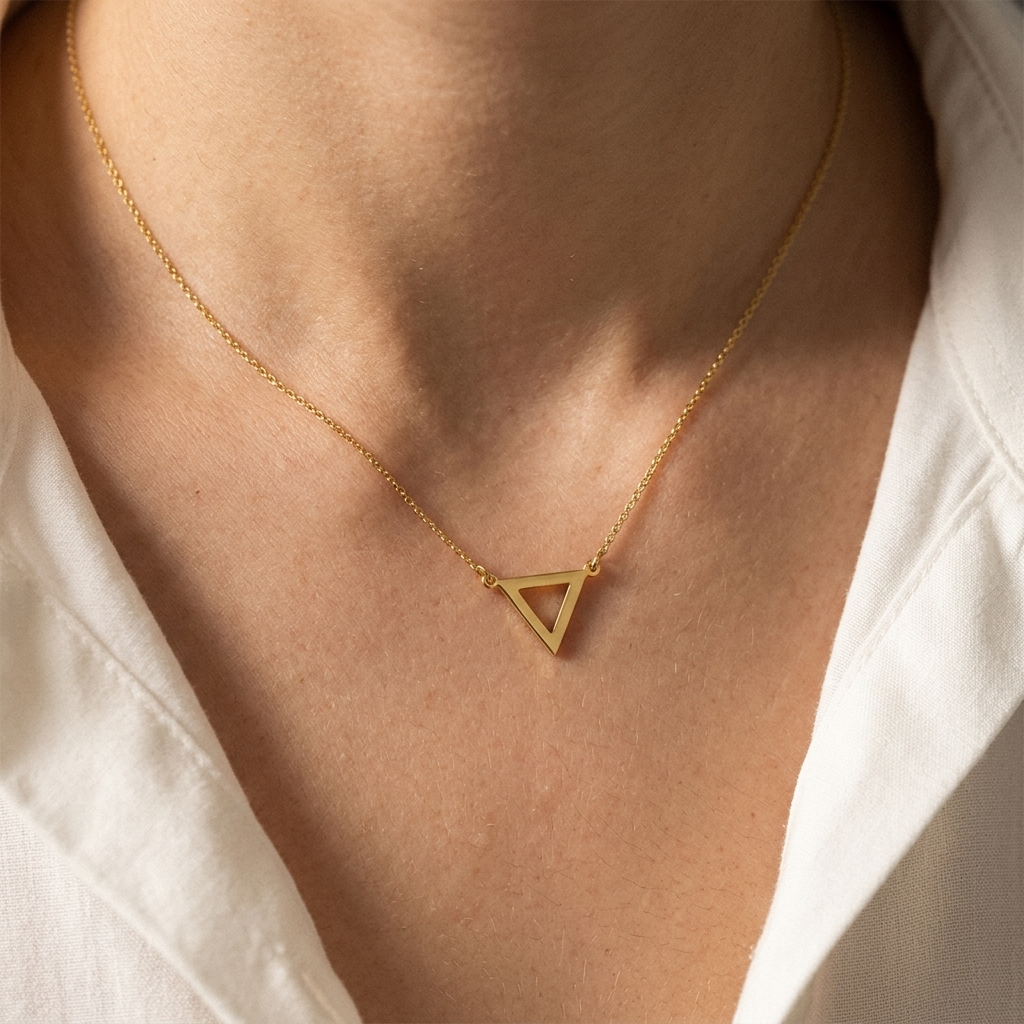 Close-up of 14K yellow gold dainty triangle necklace