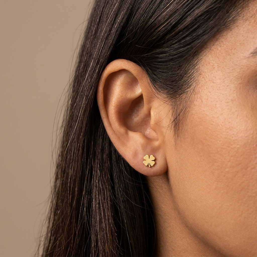 Close-up of 14K yellow gold four-leaf clover stud earrings