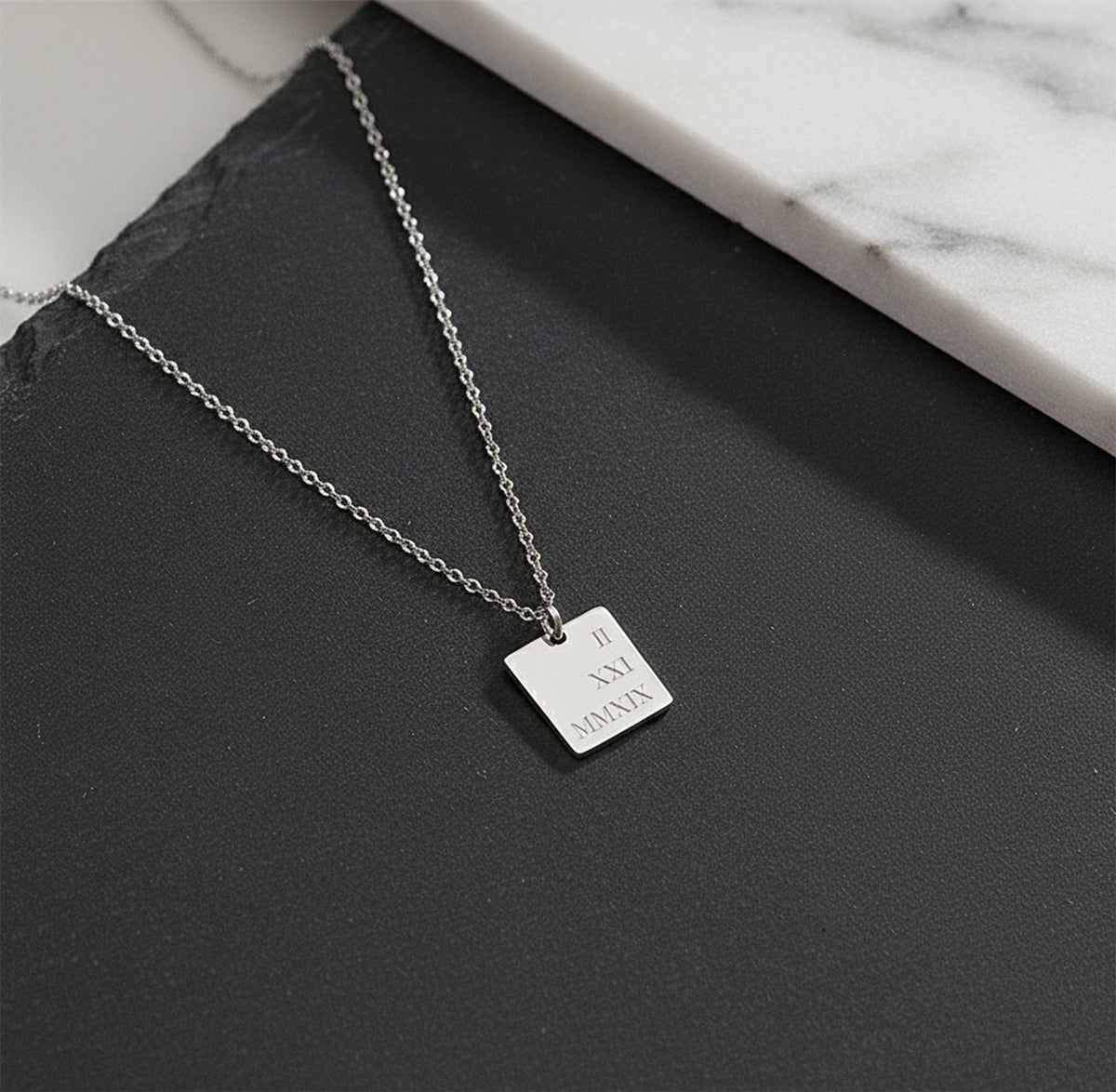 Close-up of 14K white gold custom initial letter necklace