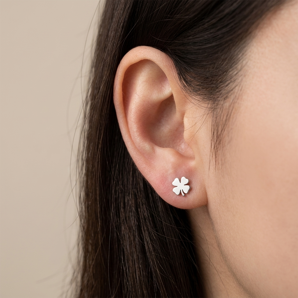 Close-up of 14K white gold four-leaf clover stud earrings
