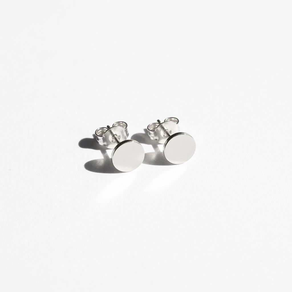 Close-up of 14K white gold personalized round disc stud earrings