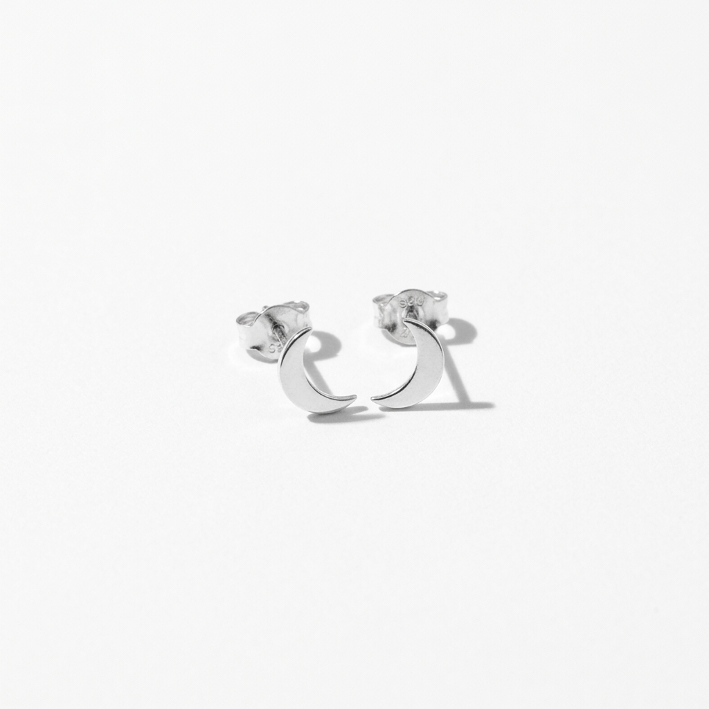 Close-up of 14K white gold crescent moon stud earrings
