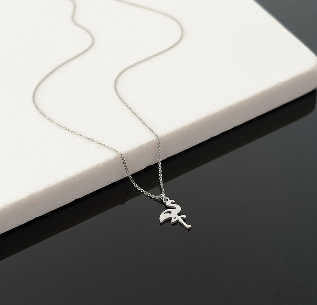 Close-up of 14K white gold flamingo necklace