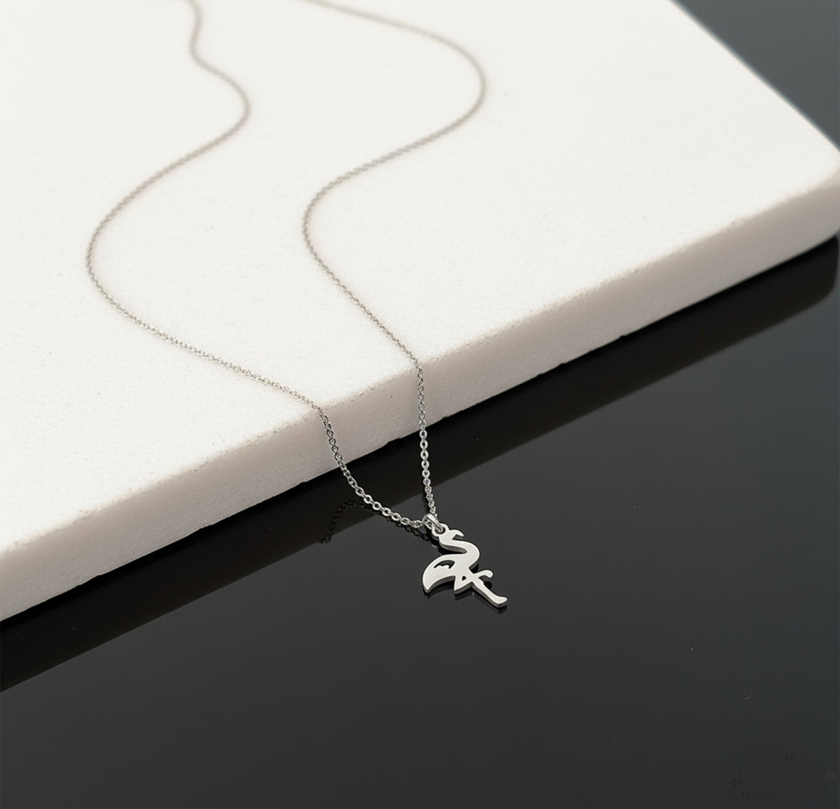 Close-up of 14K white gold flamingo necklace