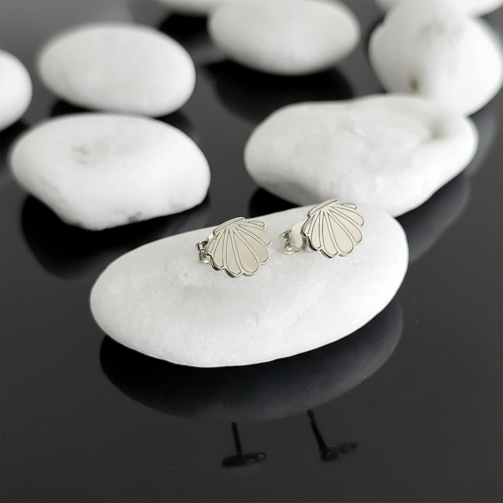 Close-up of 14K white gold seashell stud earrings