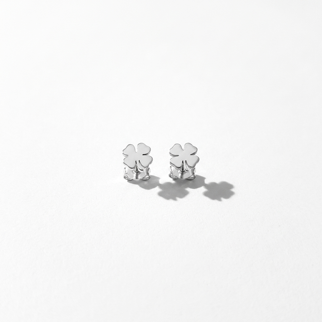 Close-up of 14K white gold four-leaf clover stud earrings