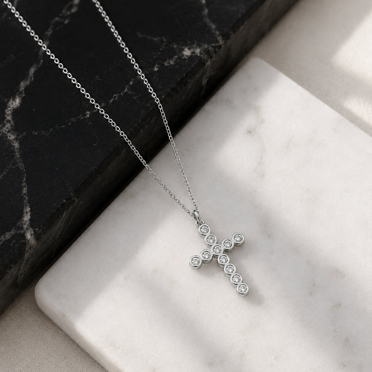 Close-up of 14K white gold diamond cross necklace