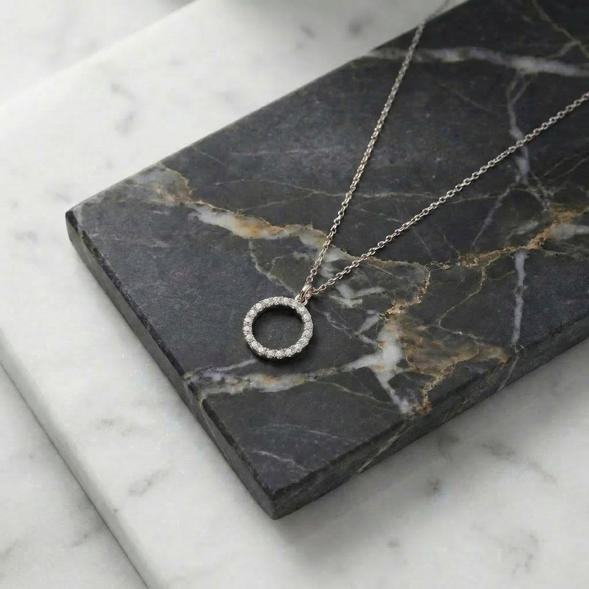 Close-up of 14K white gold lab-grown diamond circle karma necklace