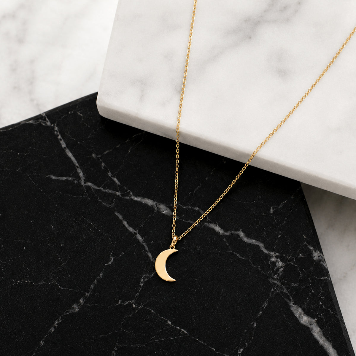 Close-up of 14K yellow gold moon necklace