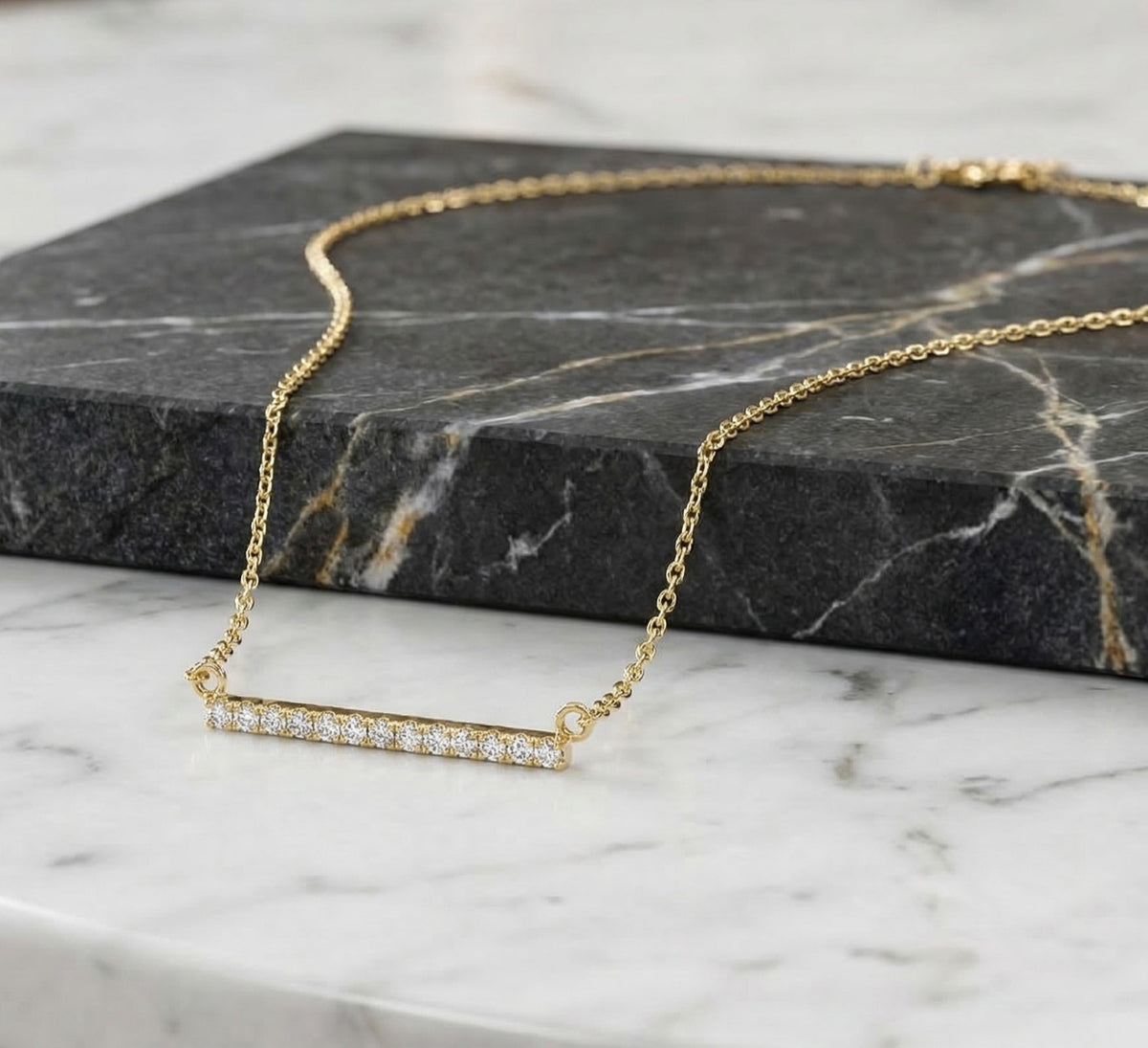 Close-up of 14K yellow gold lab-grown diamond bar necklace