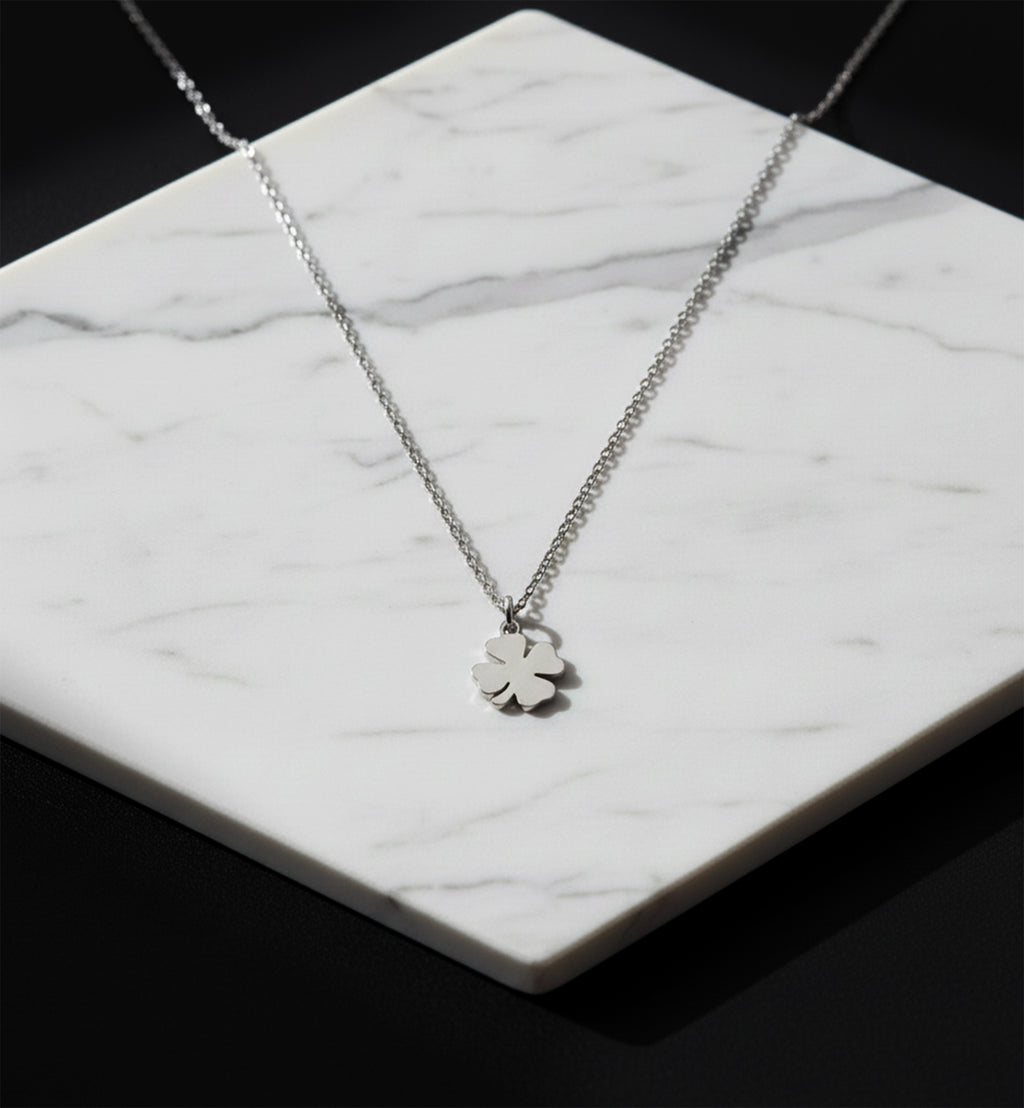 Close-up of 14K white gold four-leaf clover necklace