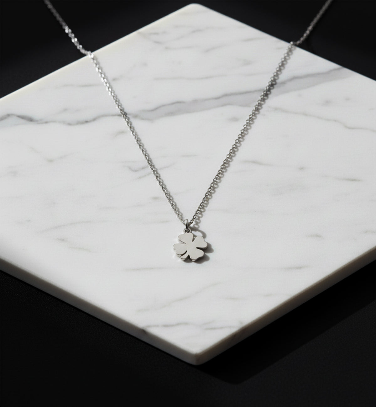Close-up of 14K white gold four-leaf clover necklace