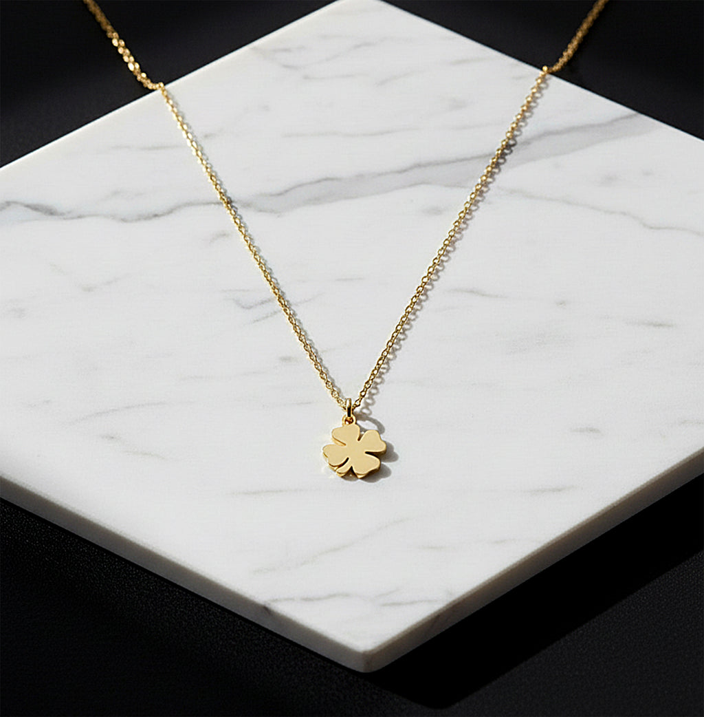 Close-up of 14K yellow gold four-leaf clover necklace