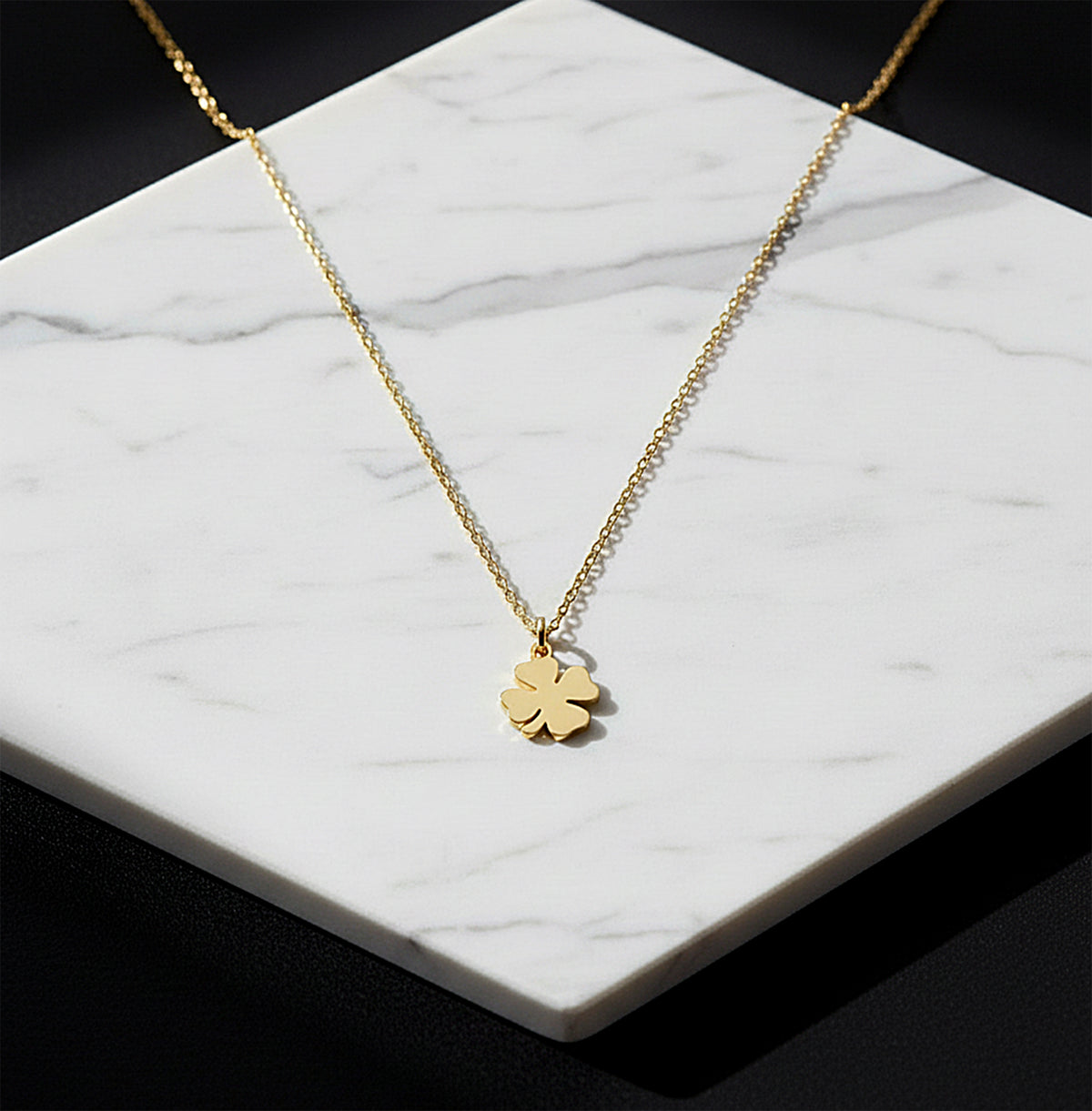 Close-up of 14K yellow gold four-leaf clover necklace